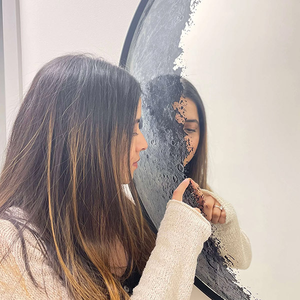 Woman in front of Moon Mirror Decor